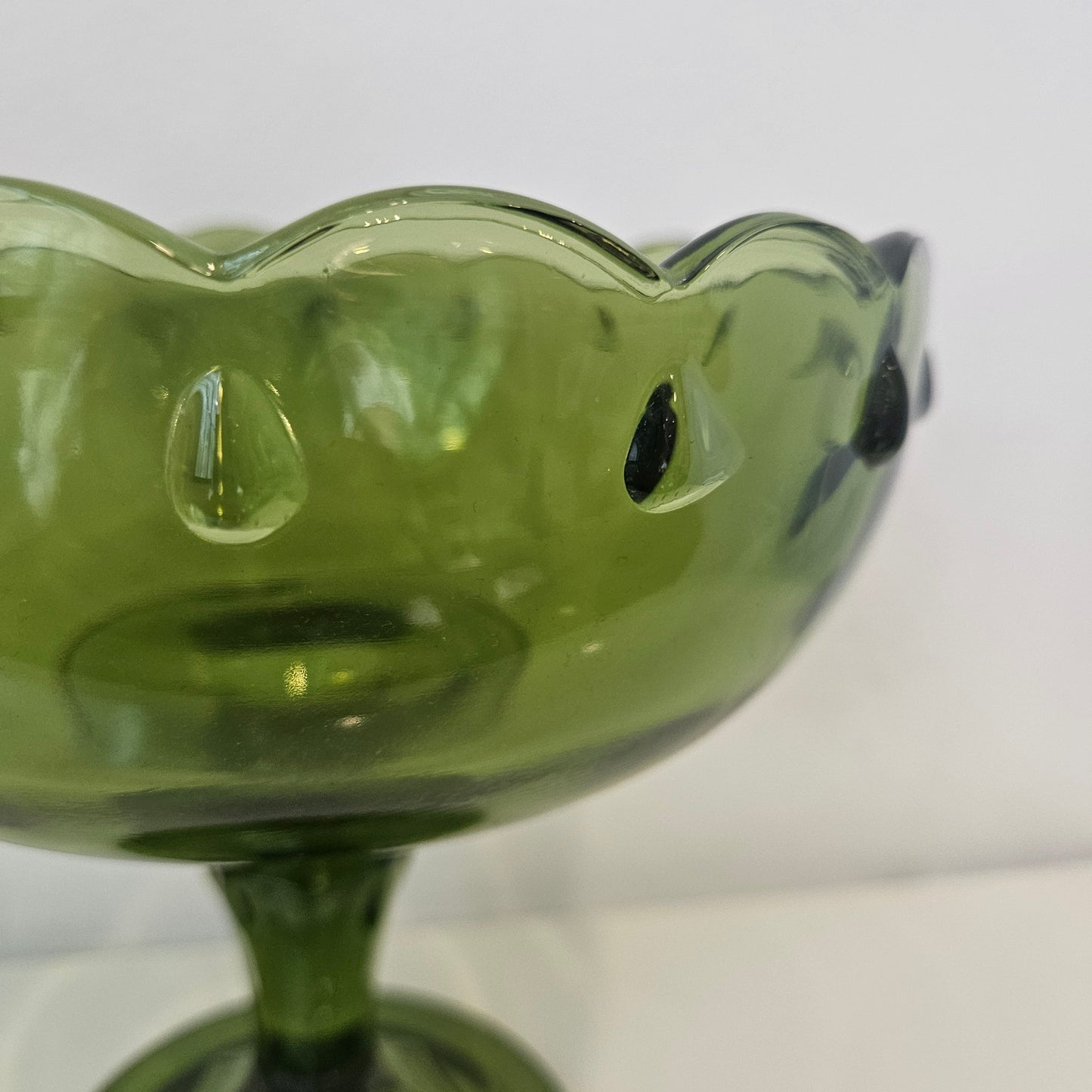 Footed green glass bowl