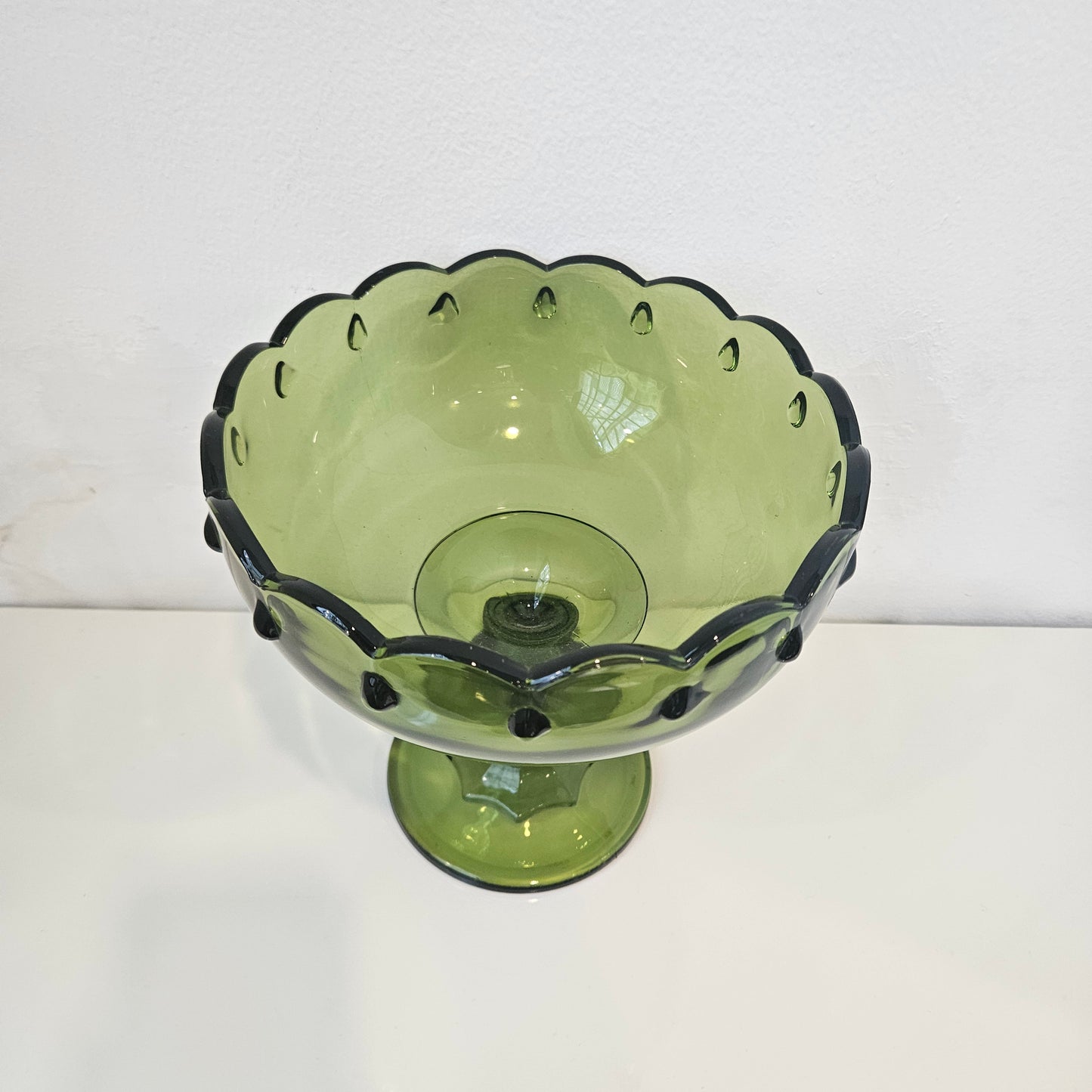 Footed green glass bowl